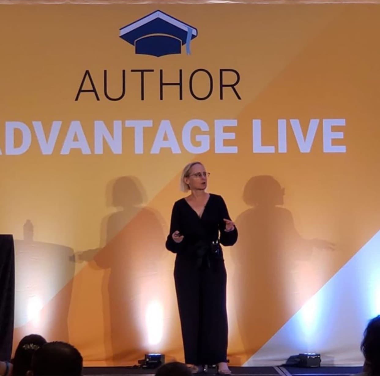 Nancy Hillis preparing to speak on stage at Author Advantage LIVE